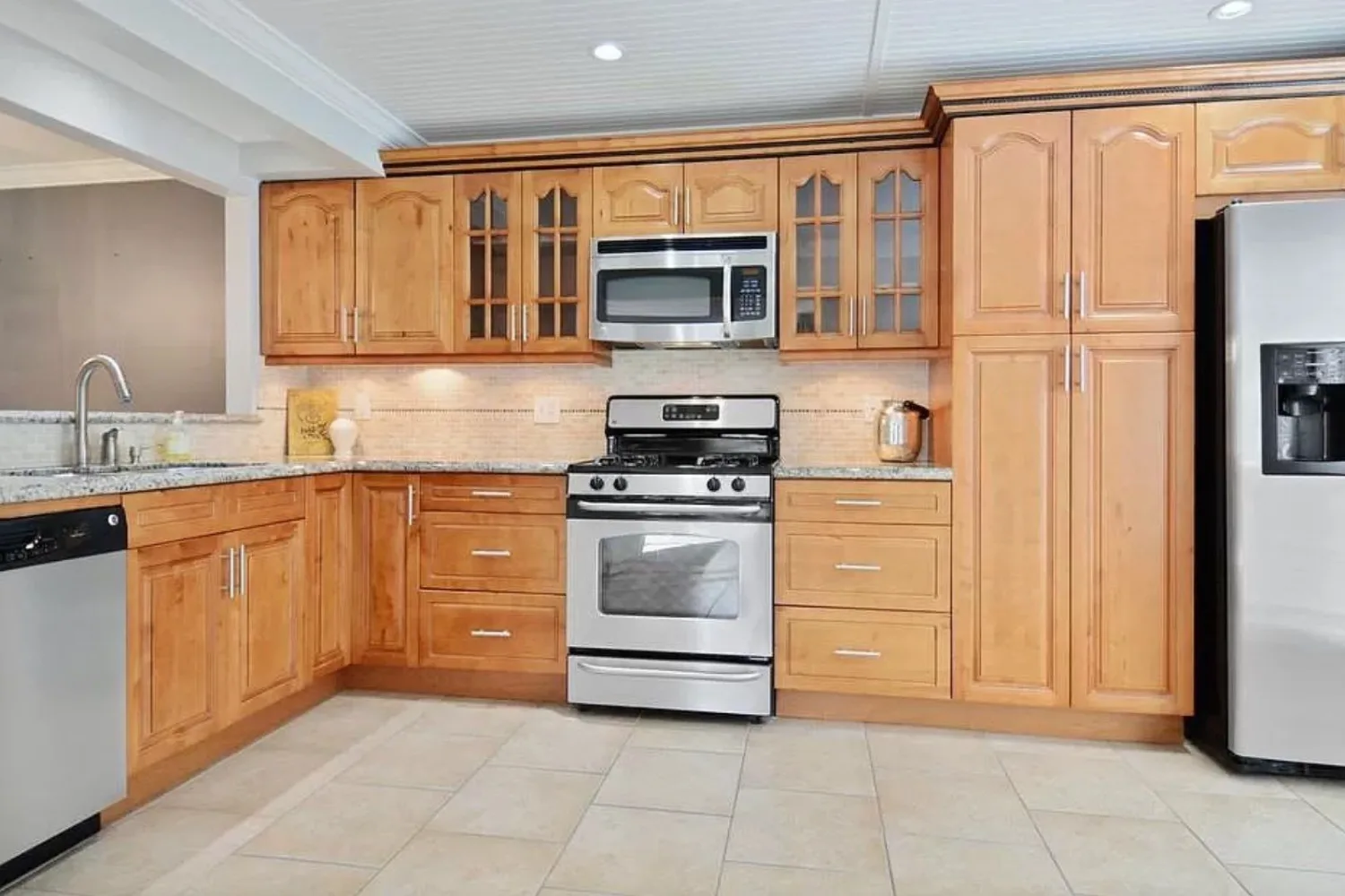 Kitchen before refinishing, with dated honey oak cabinets