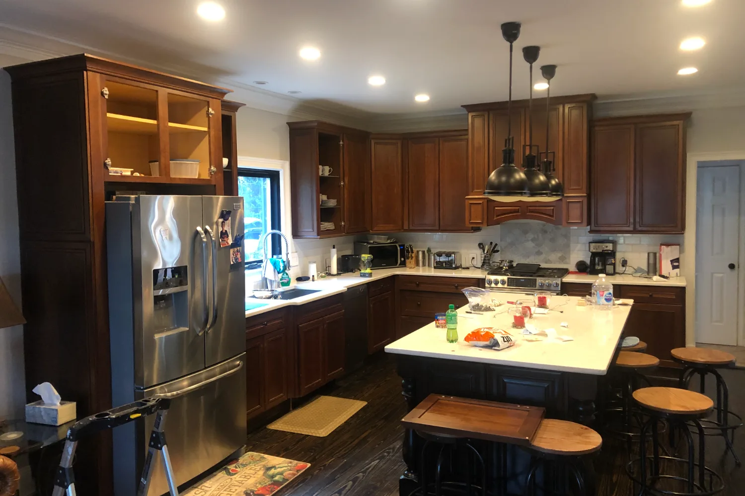 Kitchen before refinishing, with dark cherry stained cabinets